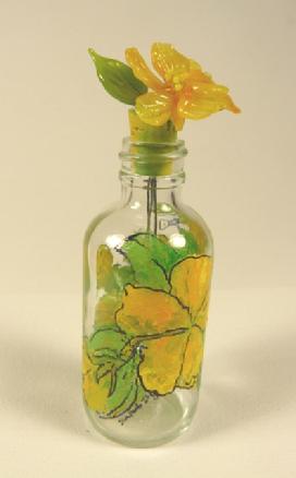 The Yellow Hibiscus is painted around the bottle with a glass hibiscus at the top